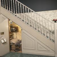 Photograph of the set of Harry Potter's cupboard under the stairs. 